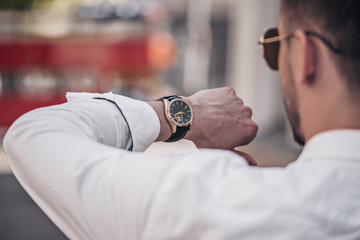 Man's hand with a stylish watch outdoor