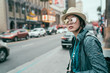 Young beautiful asian woman tourist in sunglasses and hat outdoor in city waiting for cab hailing taxi. travel transport commuter concept. girl standing by road on hollywood boulevard walk of fame.