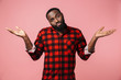 © Drobot Dean - Portrait of a confused african man wearing plaid shirt