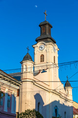 Wall Mural - Building of St. George Church in Uzhhorod city, Ukraine. It is a Roman Catholic church built in 1762-1766 in a late Baroque style. City clock placed on the tower