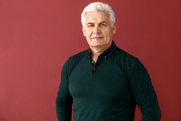 Poster - Portrait of handsome senior man on color background