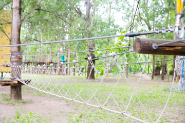 Children's Adventure Park bridges, ropes and stairs. Adventure climbing on high wired park. Course of high ropes in forest. 