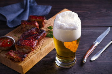 Wall Mural - Beer and pork spare ribs. Ale and meat. Beer and food concept - Image