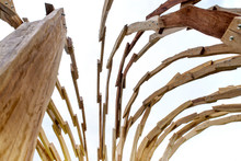 Detail Of A Wooden Skeleton In Timber On A Blue Cloudy Sky