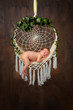 © Oksana - Sleeping newborn boy lay in dreamcatcher on wood background in the first days of life