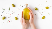 Woman's Hands Holding Bottle Of Olive Oil