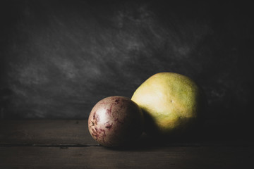 Wall Mural - Mango and passion fruit on dark background