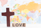 Fototapeta Motyle - Love and the Cross of Christ with the World Map in the Background