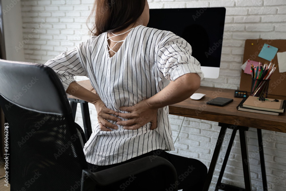 Business woman suffering from back pain in office home - obrazy, fototapety, plakaty 