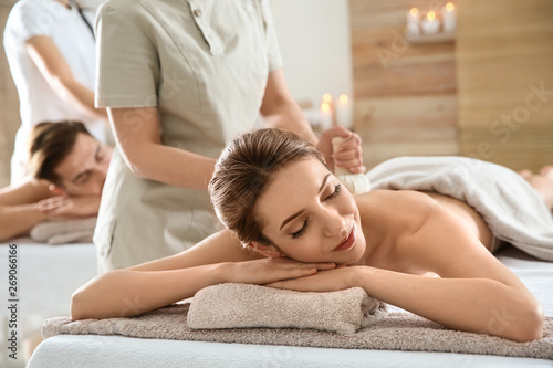 Young Enjoying Herbal Bag Massage In Spa Young Enjoying Herbal Bag Massage In Spa