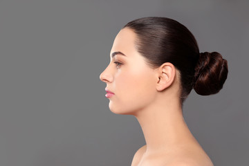 Poster - Portrait of young woman with beautiful face and natural makeup on color background, space for text