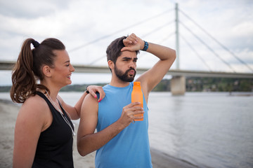 Fitness couple resting together after run