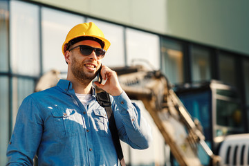 construction engineer talking on the phone on the construction site