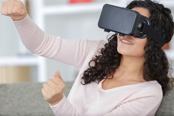 Wall Mural - happy young woman with virtual reality headset