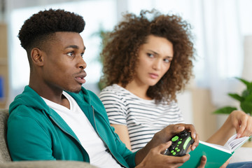 upset woman feeling offended when her boyfriend plays video-games