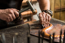 A Blacksmith Makes A Piece Of Bronze