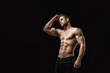 © KDdesignphoto - Muscular model young man on dark background. Fashion portrait of strong brutal guy with trendy hairstyle. Sexy naked torso, six pack abs. Male flexing his muscles. Sport workout bodybuilding concept.