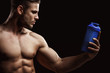 © KDdesignphoto - Model sports young man on dark background. Portrait of sporty strong muscle guy with protein drink in shaker. Sexy torso. Bodybuilding nutrition supplements, sport, workout, healthy lifestyle concep.