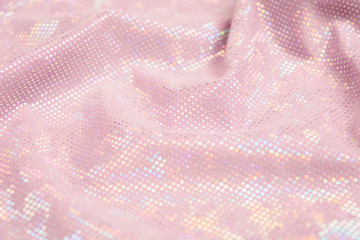 pink shiny fabric textured background. textile backdrop with waves. selective focus