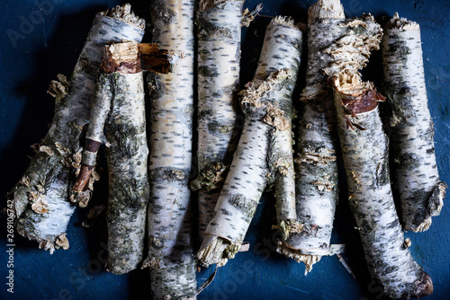 Birch Firewood Logs Stacked On The Blue Background Prepared For