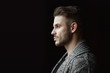 © KDdesignphoto - Muscular model young man with beard in knitted sweater on dark background. Fashion portrait of brutal sporty sexy strong muscle guy with modern trendy hairstyle. Model, fashion concept.