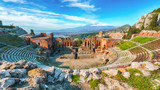 Fototapeta  - Ruins of ancient Greek theater in Taormina and Etna volcano in the background.