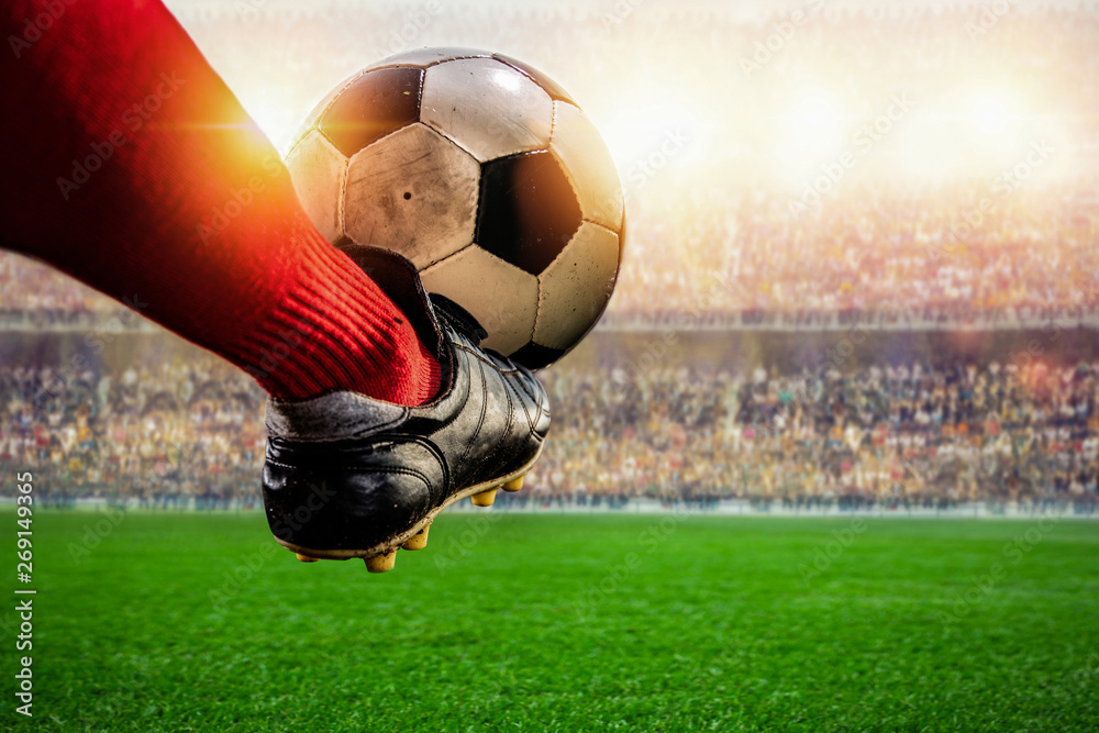 red soccer player kicking ball action in the stadium - obrazy, fototapety, plakaty 