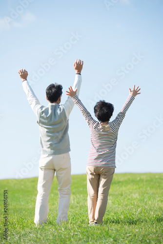 草原で両手を挙げるシニア夫婦の後姿 Adobe Stock でこのストック画像を購入して 類似の画像をさらに検索 Adobe Stock