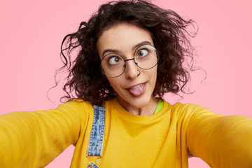 Wall Mural - silly young woman taking selfie