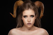 Portrait of an attractive demon woman with horns