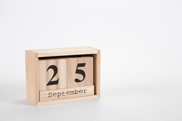 wooden calendar september 25 on a white background