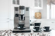 © Sviatlana - Coffee machine with cups for espresso on the kitchen table. Close-up