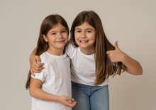 Two Cute Sisters Playing Together Having Fun Posing And Modeling