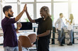 © F8  \ Suport Ukraine - Celebrating success. Cheerful young indian man and african woman giving high-five while having coffee break in creative office