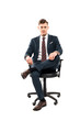 © LIGHTFIELD STUDIOS - confident businessman sitting on chair and looking at camera isolated on white