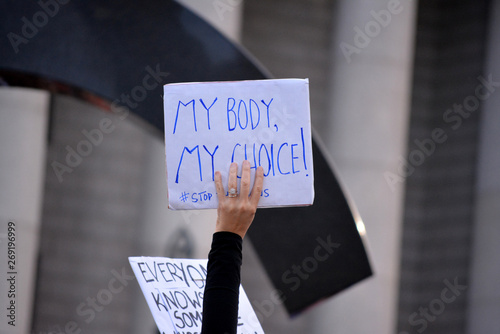People holding signs in New York City protesting abortion bans that have swept across parts of the United States.