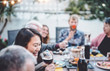 © Alessandro Biascioli - Happy family cheering and dining together outdoor - People with different ages and ethnicity having fun at barbecue dinner party - food and drink, retired and young people concept