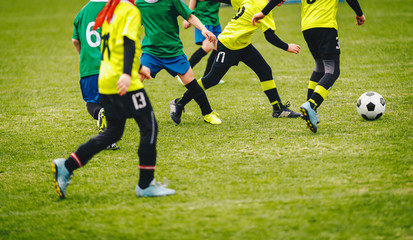 Soccer background. Players kicking soccer ball on green field. Football tournament match game for youth teams