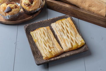 close up of bakery and pineapple pie on wooden board