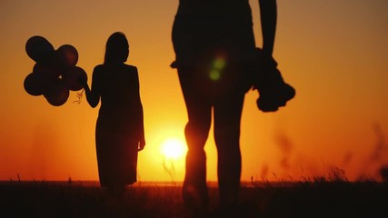 Wall Mural - Carefree child with a toy in hand runs to mom at sunset