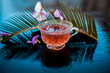 Detoxifying floral beneficial tea of rosemary in a transparent glass cup along with its flowers and leaves also.