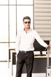 © Arunporn - Young and smart businessman with sunglasses, suitcase and travel document such as air ticket, hotel booking document and passport with travel concept,summer vacation concept, summer holiday concept