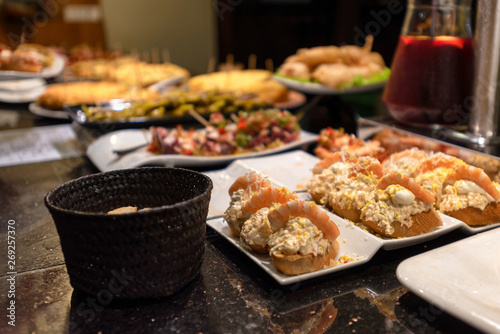 Fotografie, Tablou  Servings of various pintxos or tapas at a bar in San Sebastian, Spain