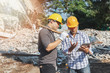 © skarie - Demolition control supervisor and contractor discussing on demolish building.