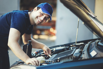 Professional car mechanic working in auto repair service.