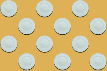 Poster - White plates on a yellow flat background. Copy space