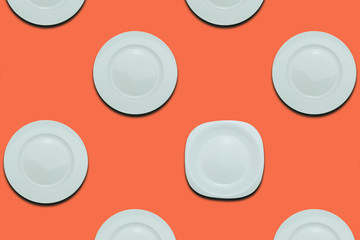 Poster - White round plates and one different plate on a coral orange flat background. Copy space
