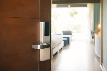 Hotel room , Condominium or apartment doorway with open door in front of blur bedroom background