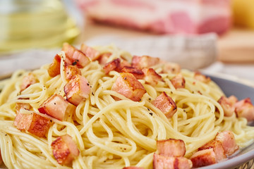 Wall Mural - Close up carbonara pasta. Spaghetti with bacon, egg, parmesan cheese and cream sauce. Side view. Traditional italian cuisine.