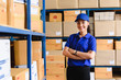 © stnazkul - Portrait of woman delivery staff in blue uniform in warehouse